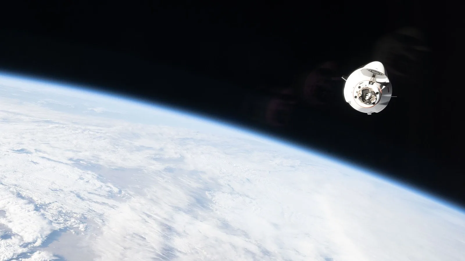 A SpaceX cargo Dragon spacecraft approaching the International Space Station above Earth (file photo)